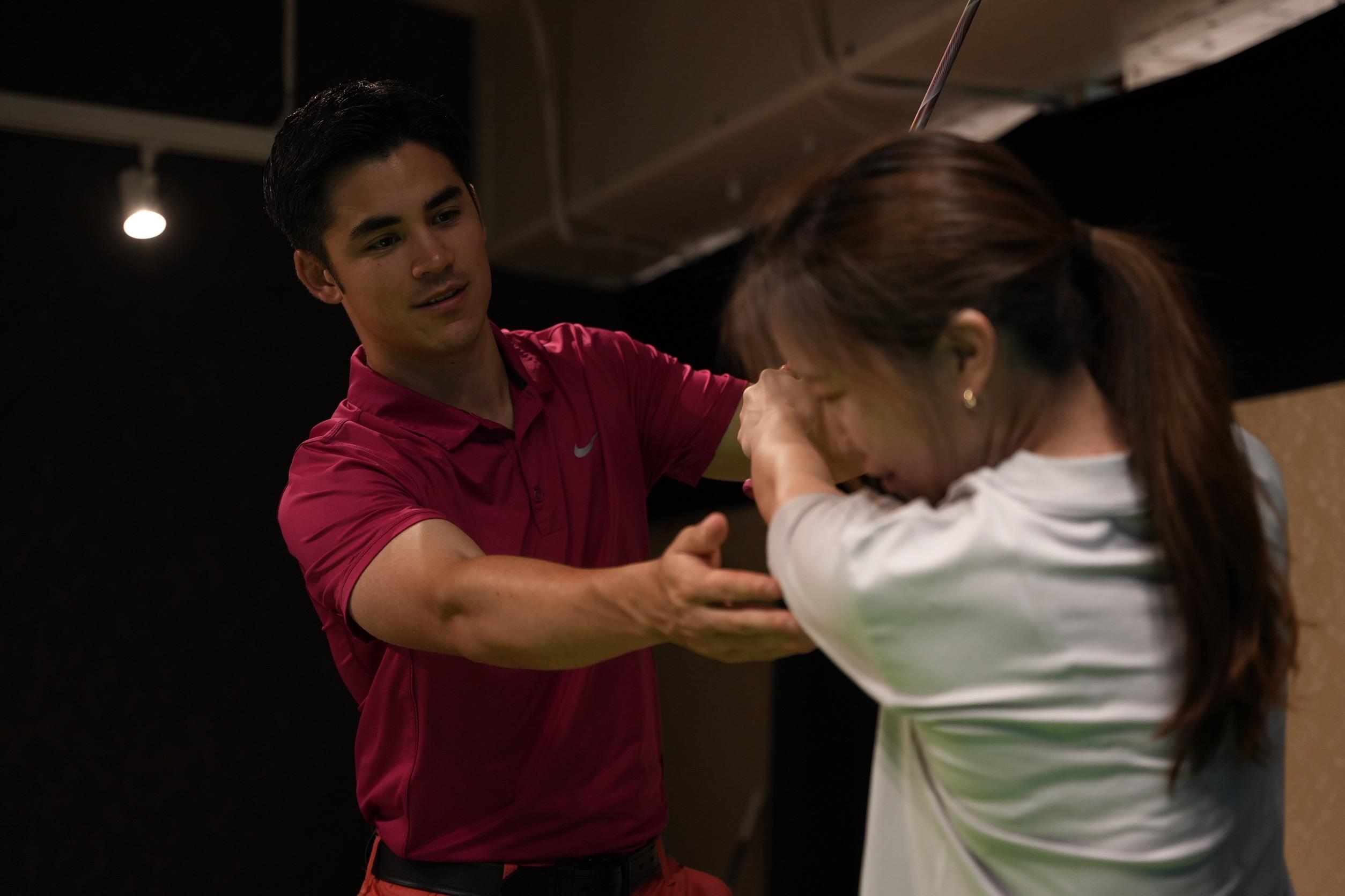 Indoor lesson with Louis guiding a student swing