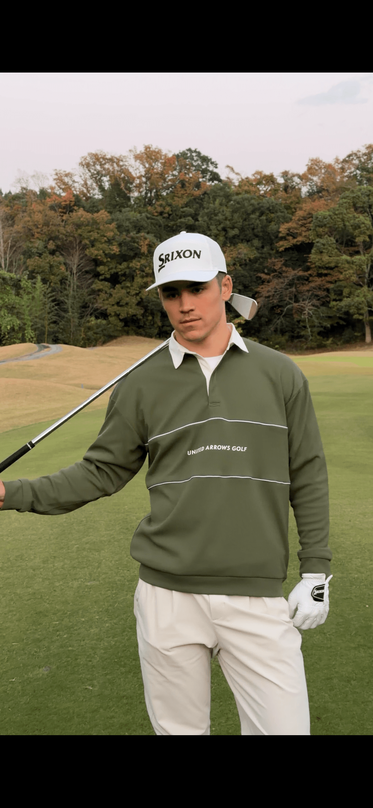 Portrait of Louis holding a club in Under Armour and Srixon gear