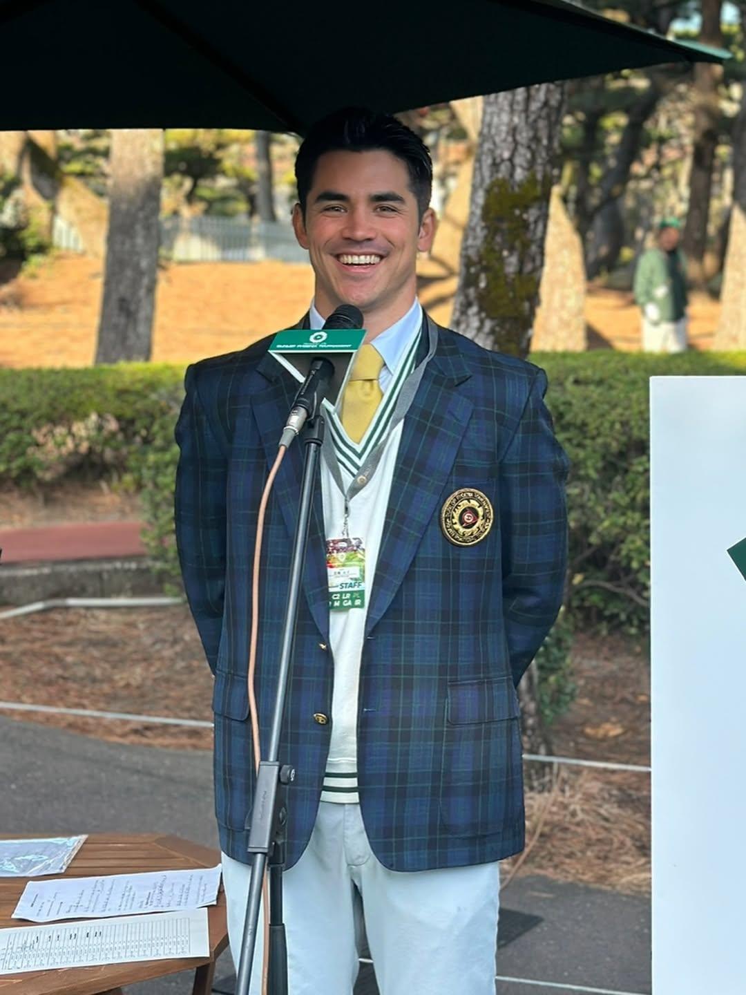 Louis as MC at a golf tournament, full body shot